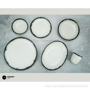 Reactive glazed stoneware dinner set with black rim